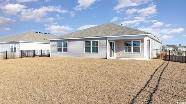 rear view of property featuring a yard