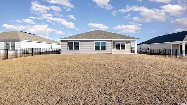 rear view of property with a yard