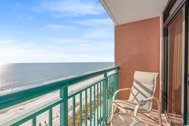 balcony with a beach view and a water view