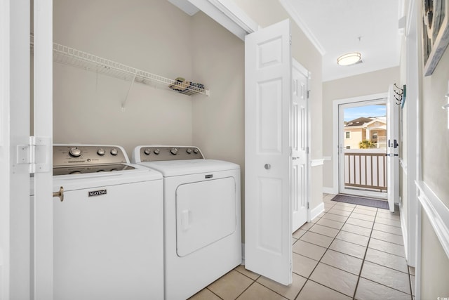 laundry room featuring washing machine and dryer and light tile patterned floors