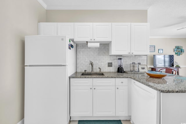 kitchen featuring stone counters, sink, white cabinets, and white appliances