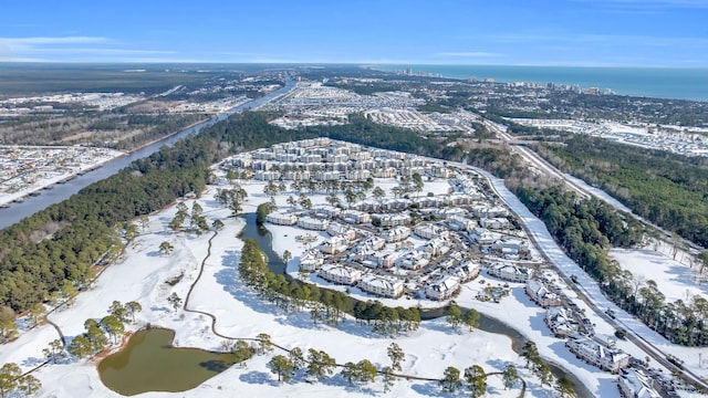 snowy aerial view featuring a water view