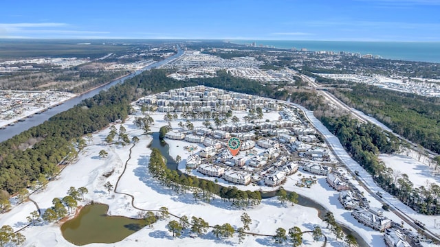 snowy aerial view with a water view