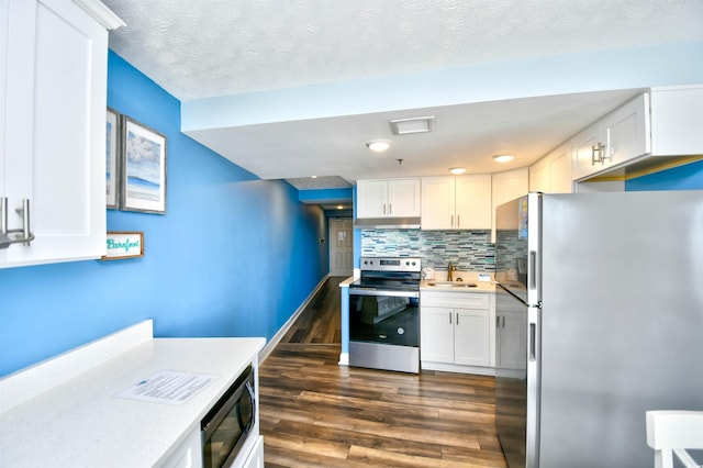 kitchen with stainless steel appliances, sink, and white cabinets