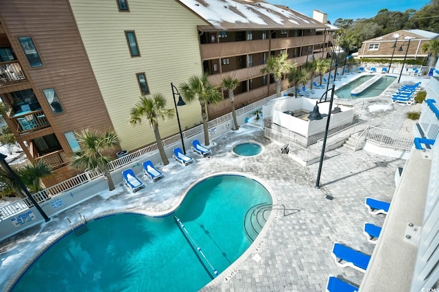 view of pool with a hot tub