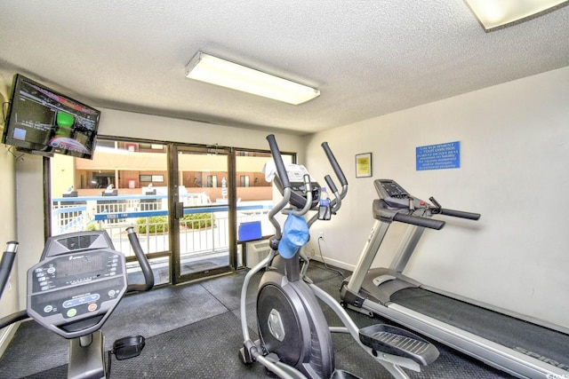 gym featuring a textured ceiling