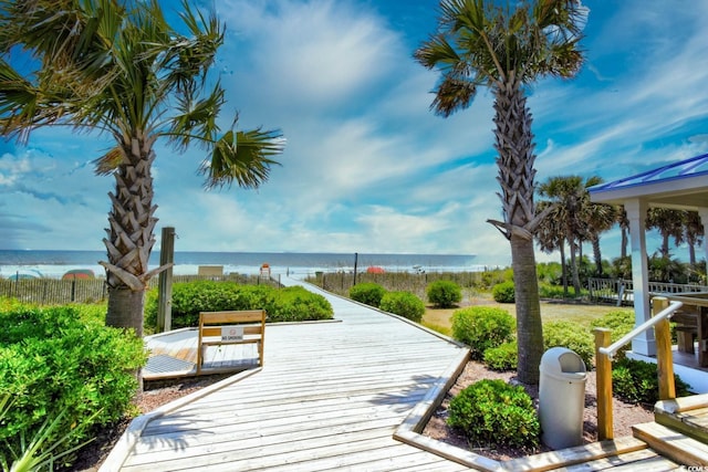 view of home's community with a deck with water view