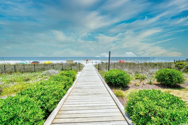 view of community featuring a beach view and a water view