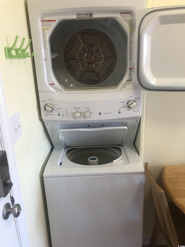 laundry area with stacked washer / drying machine