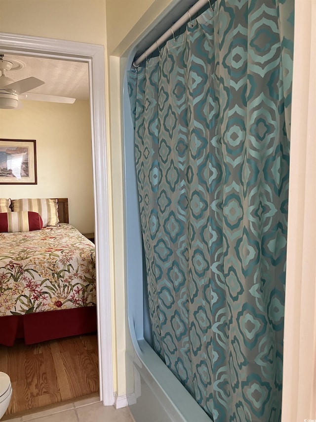 2710 Ocean Blvd S Unit 406, Myrtle Beach, SC 29577 - full bath featuring shower / bathtub combination with curtain, tile patterned flooring, ceiling fan, and ensuite bathroom