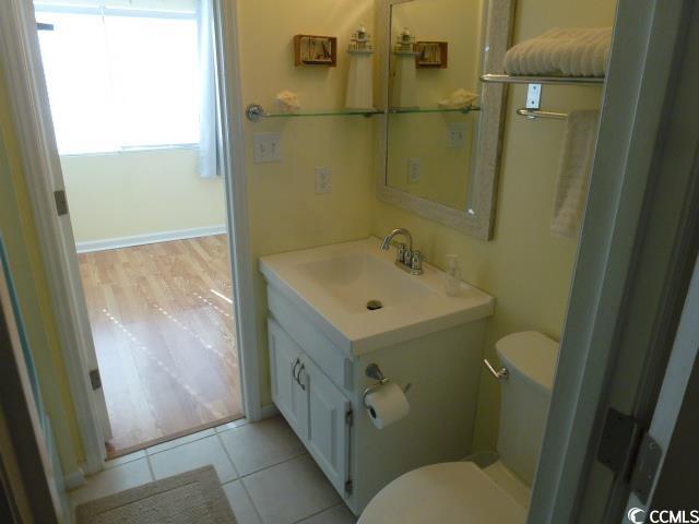 bathroom with vanity, toilet, and tile patterned flooring