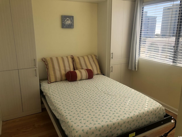 bedroom featuring dark hardwood / wood-style flooring