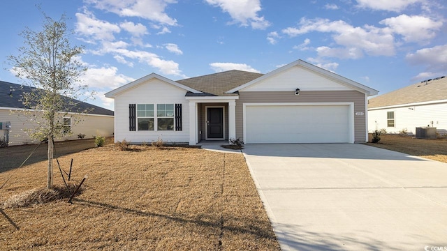 single story home featuring a garage and cooling unit