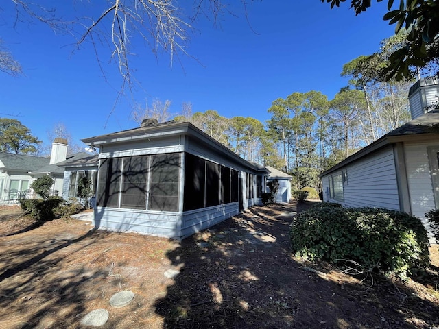 view of home's exterior with a sunroom