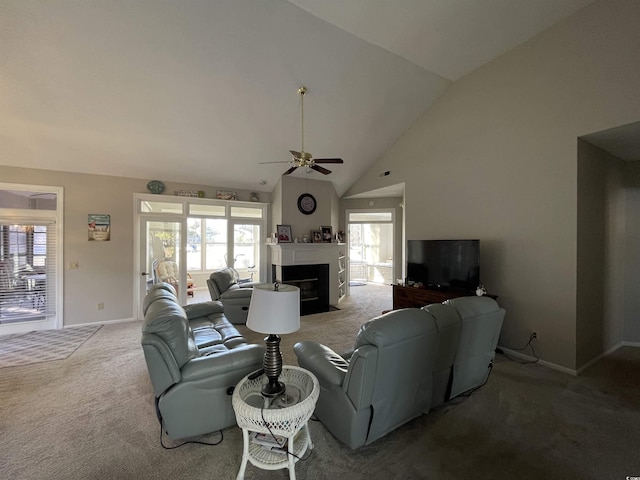 living room with ceiling fan, plenty of natural light, high vaulted ceiling, and carpet