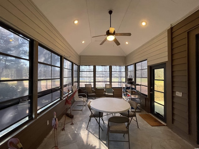 sunroom / solarium featuring ceiling fan, plenty of natural light, and vaulted ceiling