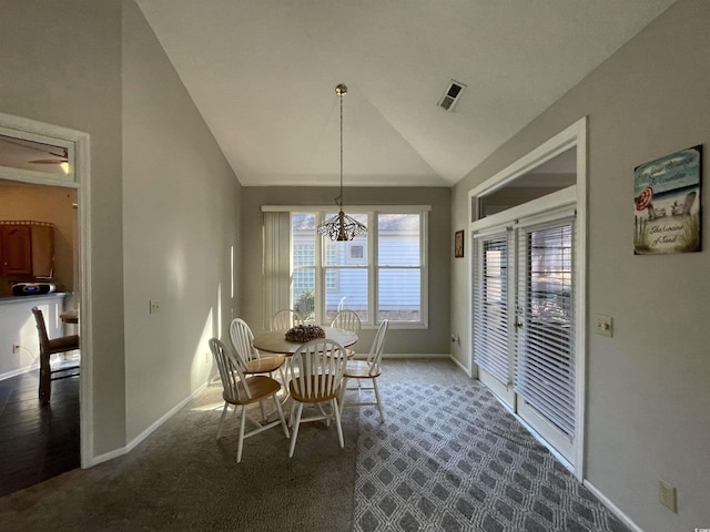 carpeted dining area featuring lofted ceiling