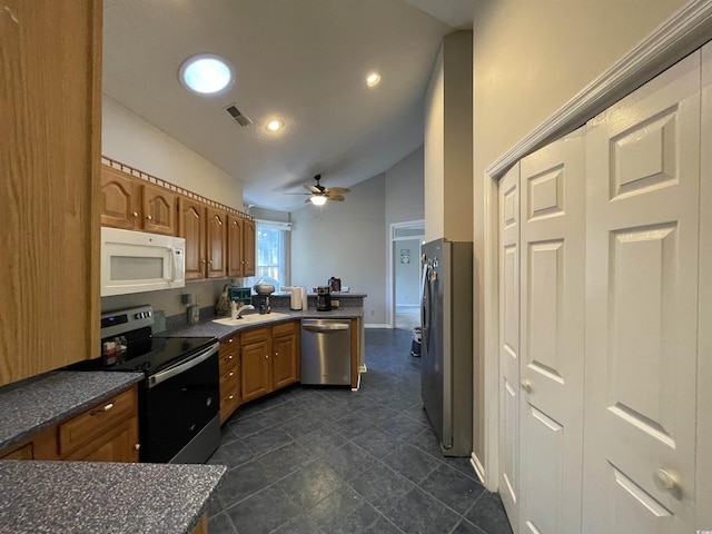 kitchen featuring vaulted ceiling, appliances with stainless steel finishes, sink, ceiling fan, and kitchen peninsula