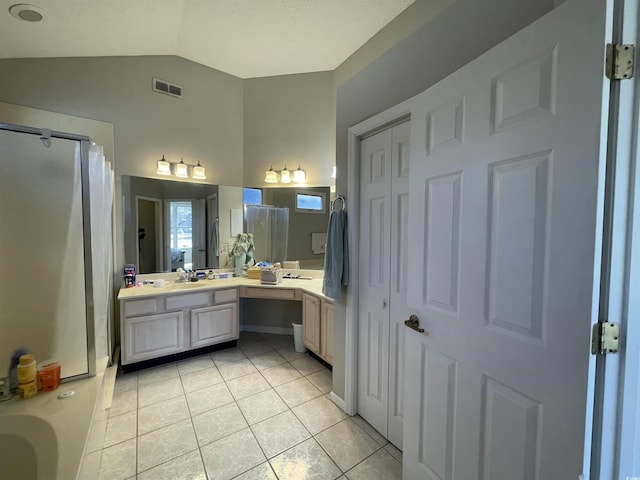 bathroom featuring vanity, tile patterned floors, shower with separate bathtub, and lofted ceiling