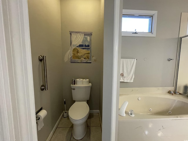 bathroom featuring a tub to relax in, toilet, and tile patterned flooring