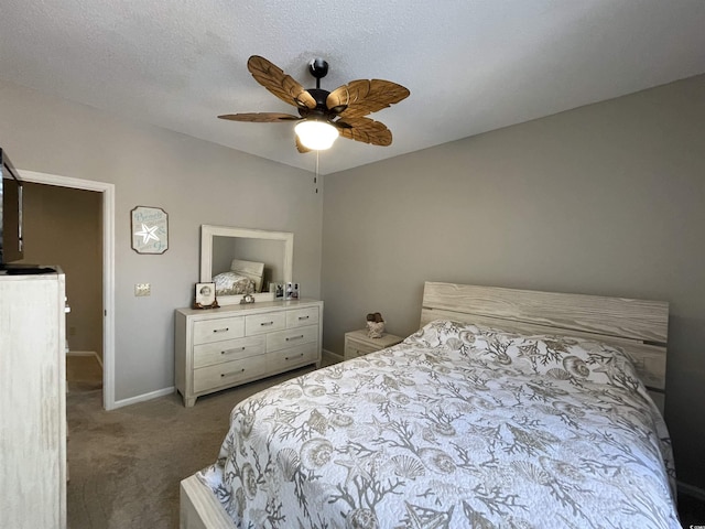 bedroom featuring a textured ceiling, carpet floors, and ceiling fan