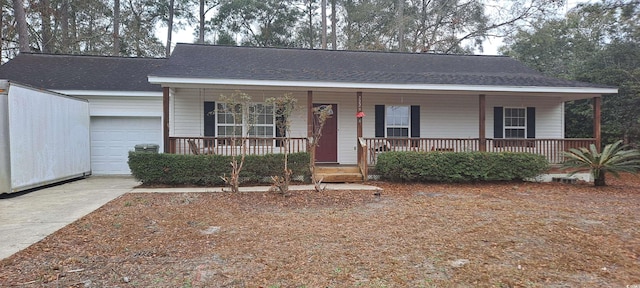 single story home with concrete driveway, a porch, an attached garage, and a shingled roof