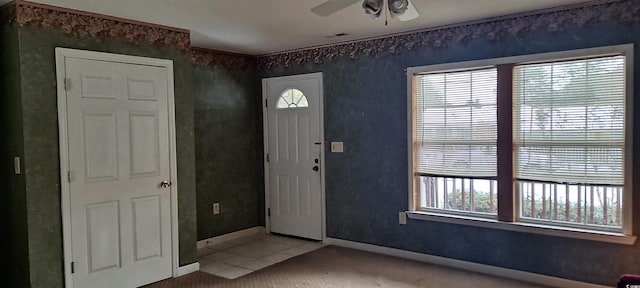 carpeted entryway featuring ceiling fan, visible vents, and baseboards