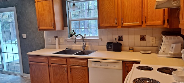 kitchen with white appliances, brown cabinetry, ventilation hood, light countertops, and a sink