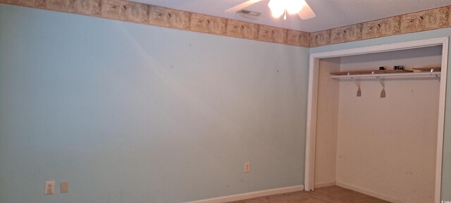 carpeted empty room with ceiling fan