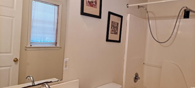 bathroom featuring toilet, bathtub / shower combination, and a wealth of natural light