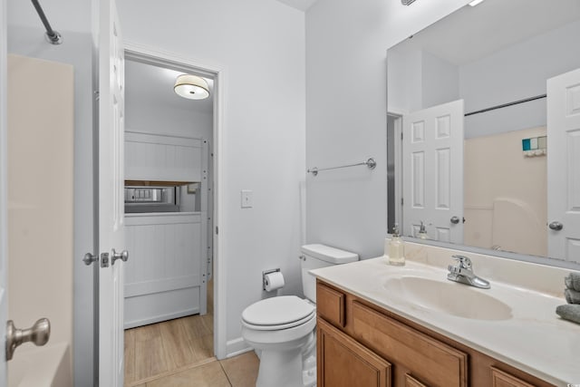 full bathroom with tile patterned floors, vanity, toilet, and washtub / shower combination