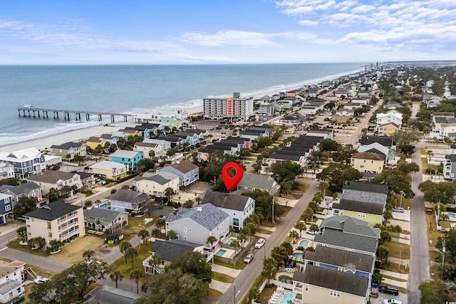 drone / aerial view featuring a water view and a view of the beach