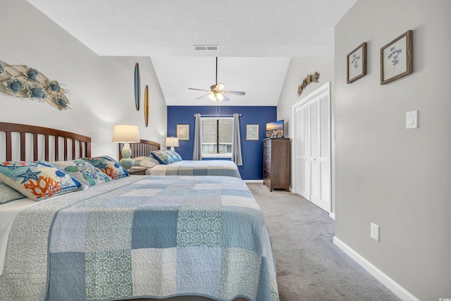 carpeted bedroom featuring visible vents, ceiling fan, baseboards, vaulted ceiling, and a textured ceiling