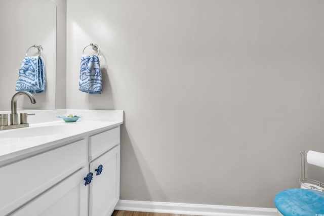 bathroom featuring baseboards and vanity