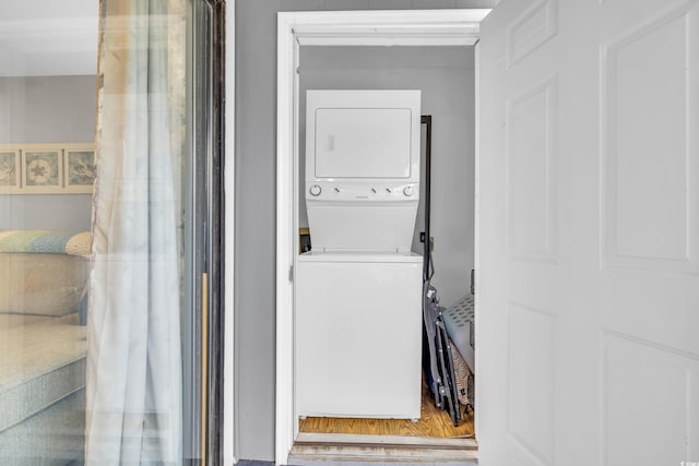 washroom with laundry area and stacked washer / drying machine