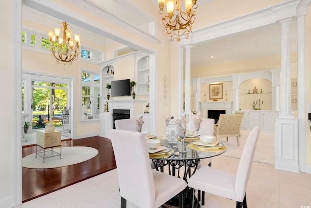 dining space with decorative columns, light tile patterned floors, and built in features