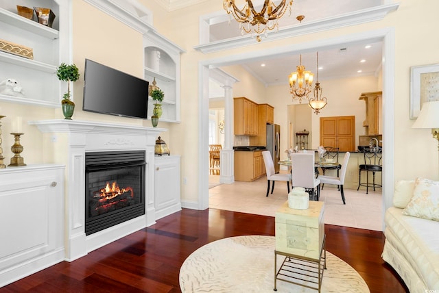 living room with built in shelves, tile patterned floors, and an inviting chandelier