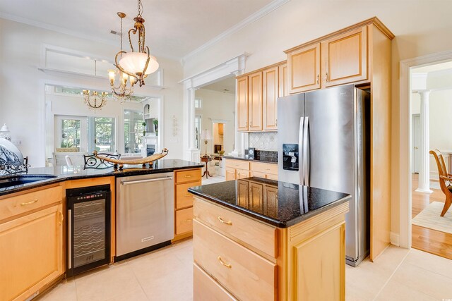 kitchen featuring stainless steel appliances, beverage cooler, light brown cabinetry, and dark stone counters