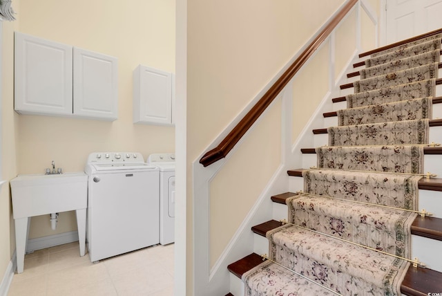 stairway featuring separate washer and dryer and tile patterned floors