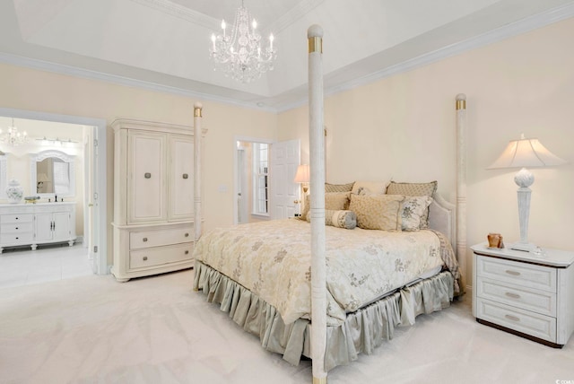 carpeted bedroom featuring an inviting chandelier, connected bathroom, and a tray ceiling