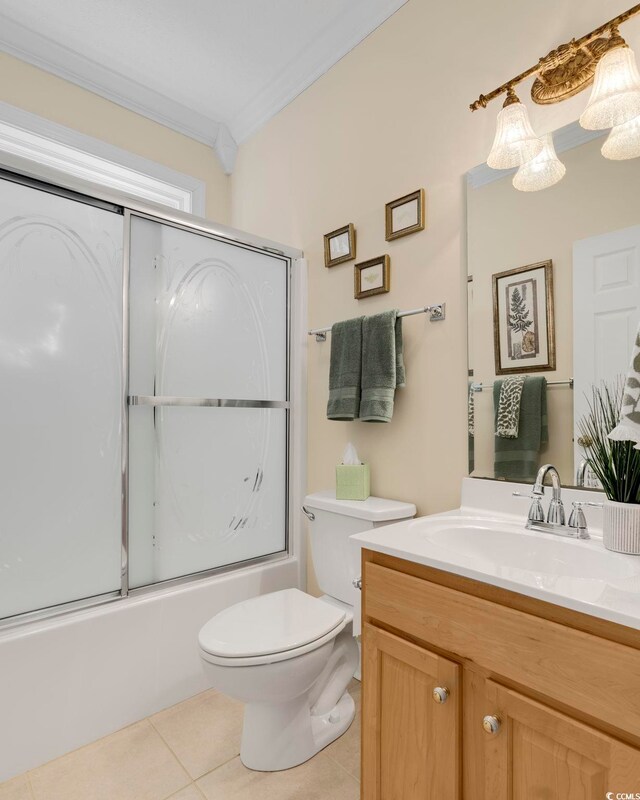 full bathroom with toilet, shower / bath combination with glass door, ornamental molding, vanity, and tile patterned flooring