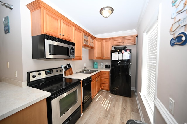 kitchen with crown molding, sink, light hardwood / wood-style floors, and black appliances