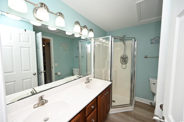 bathroom featuring walk in shower, vanity, toilet, and hardwood / wood-style flooring