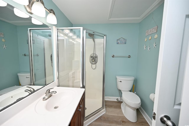 bathroom with hardwood / wood-style flooring, vanity, toilet, and walk in shower