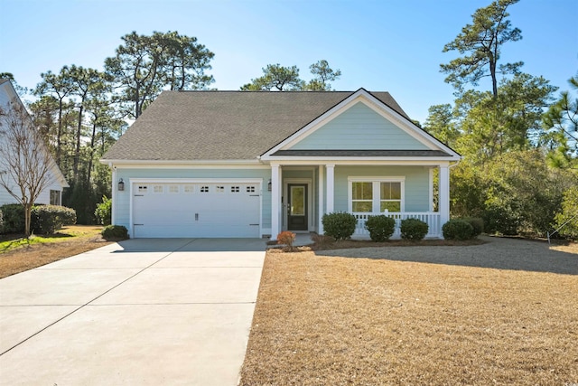 view of front of property with a porch and a garage