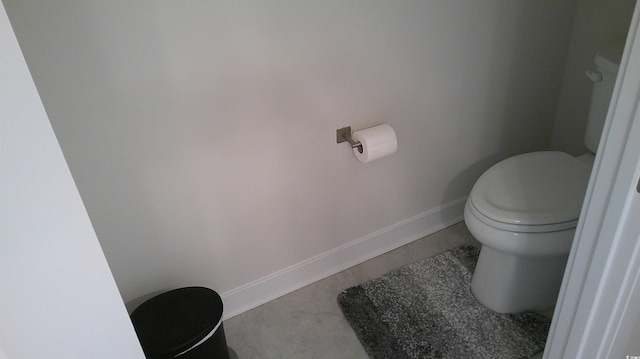 bathroom with toilet and baseboards