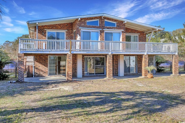 rear view of property featuring a patio and a yard