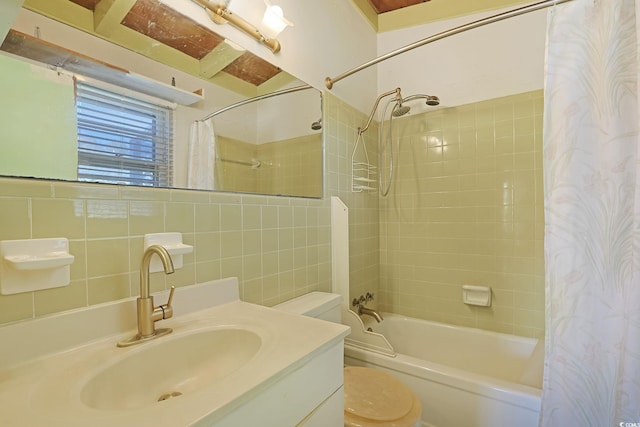 full bathroom with tasteful backsplash, tile walls, shower / bath combination with curtain, vanity, and toilet