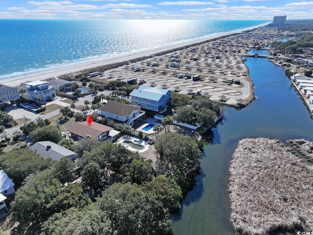 bird's eye view featuring a water view and a beach view