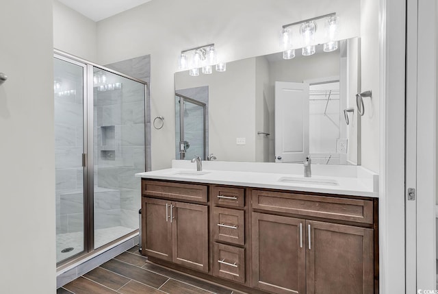 bathroom with vanity and a shower with shower door